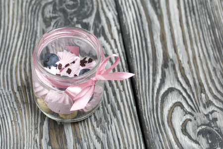 Zephyr in a jar, decorated with blueberries. On painted pine planks.の写真素材