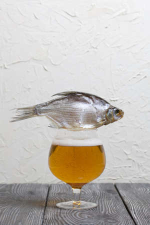A glass of beer. There is a roach on the glass.の写真素材