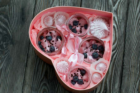 Zephyr in a jar, decorated with blueberries. Packaged in a heart-shaped gift box. On painted pine...