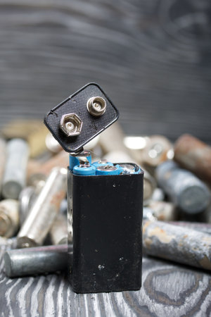 Corroded used batteries. On pine boards. Disposal of hazardous waste.の写真素材