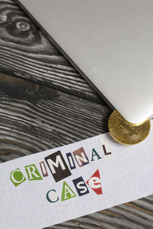 The phrase Criminal case made of letters cut from a magazine and pasted on a sheet of paper. Bitcoin...