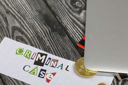 The phrase Criminal case made of letters cut from a magazine and pasted on a sheet of paper. Bitcoin...
