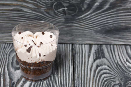 Zephyr in a glass. With biscuit and chocolate. On pine boards painted black and white.