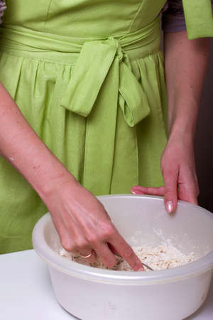 The woman is kneading the dough. Butter, sugar and flour in a bowl. Levington cake, stages of...