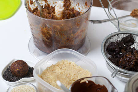 Dried fruit and nut sweets. The ingredients and tools for cooking are spread out on the table....