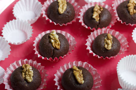 Dried fruit and nut sweets. Decorated with walnut swarms. Made at home in self-isolation during the...