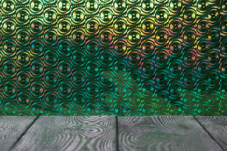 Brushed pine boards painted black and white. The iridescent surface is green.