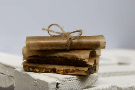 Nut & Dried Fruit Energy Bars. Wrapped in paper and tied with twine. Close-up shot.