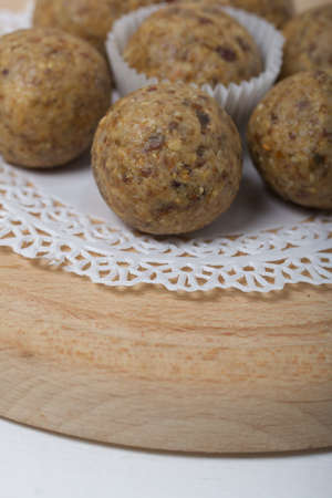 Dried fruit and oatmeal sweets. On black pine boards. Close-up shot.