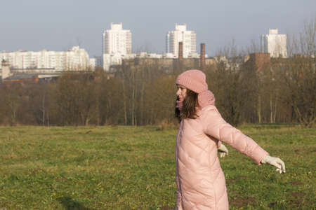 Girl in autumn clothes. Does gymnastics outdoors in the park.の写真素材