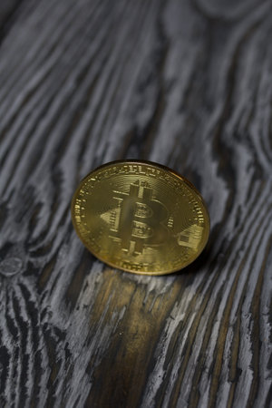 Bitcoin on black pine boards. Close-up shot.