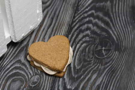 Gingerbread cookie with marshmallows. Zephyr sandwich on black pine boards.の写真素材