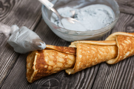 Ingredients for making dessert. Cream cheese of different colors, waffle cones and chocolate.の写真素材