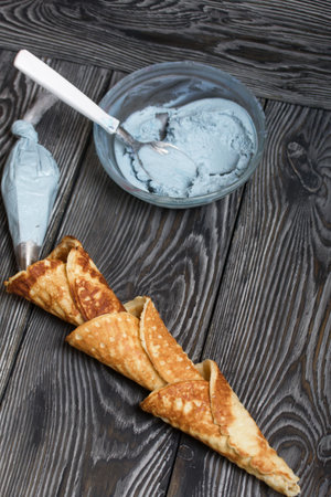 Ingredients for making dessert. Cream cheese of different colors, waffle cones and chocolate.の写真素材