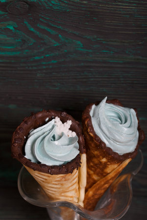 Wafer cones filled with marshmallows. With white and dark chocolate. Decorated with pastille...