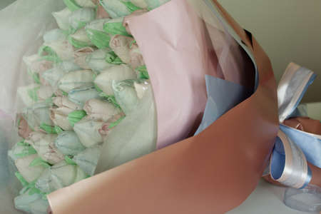 Zephyr bouquet. Marshmallow tulips are collected in a bouquet and wrapped in paper.の写真素材