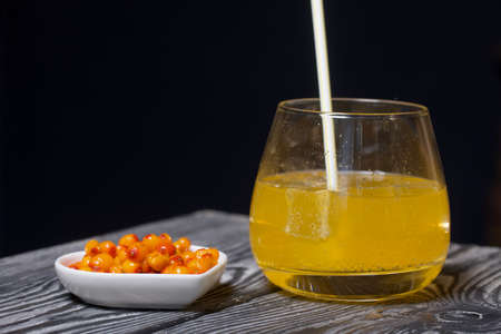 Cocktail with sparkling wine and sea buckthorn. Sea buckthorn bellini with ice.
