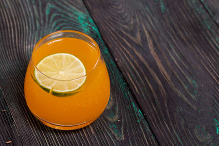 A glass of alcohol. Decorated with a lime wedge.の写真素材