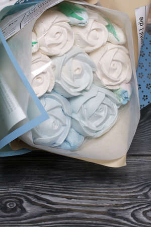 Zephyr bouquet in wrapping paper. Tulips and roses from zephyr. Close-up shot.の写真素材