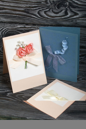 Handmade greeting cards. Various colors and decorative elements. They lie on pine boards.
