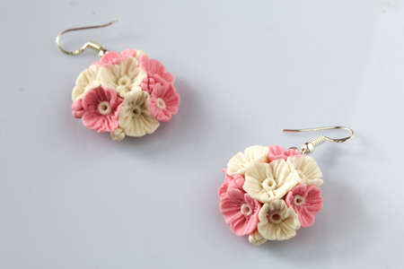 Handmade jewelry. Earrings made of polymer clay. Lies on a white surface.の写真素材