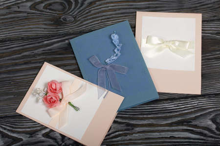 Handmade greeting cards. Various colors and decorative elements. They lie on pine boards.