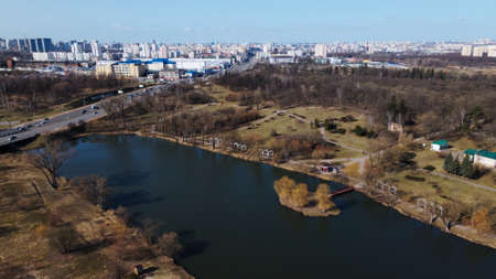 Flight over the city park. The lake and the island are visible. Spring in the city.の写真素材