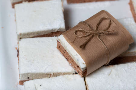 Portion marshmallow with cocoa and cranberries. Wrapped in paper and tied with string. Two-layer...