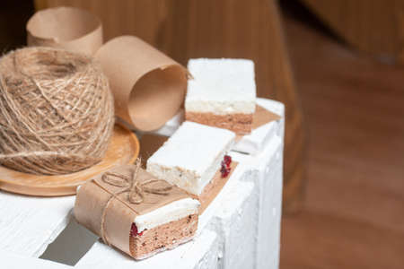Portion marshmallow with cocoa and cranberries. Wrapped in paper and tied with string. Two-layer zephyr.の写真素材
