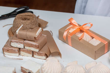 Portion marshmallow with cocoa and cranberries. Wrapped in paper and tied with string. Two-layer...