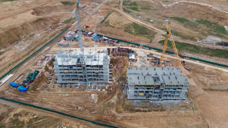 Construction site with multi-storey buildings under construction. Modern urban development. Aerial...