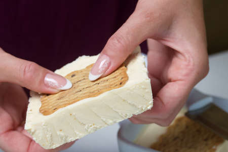 Woman cuts homemade ice cream. Cookies and cream. Close-up shot.の写真素材