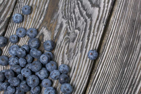 Blueberries are scattered on pine boards. Close-up shot.の写真素材