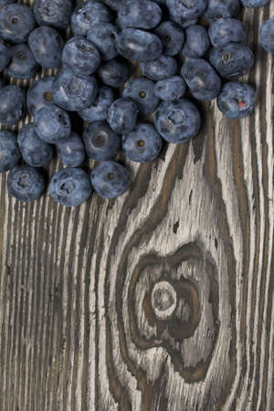 Blueberries are scattered on pine boards. Close-up shot.の写真素材