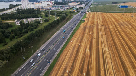 Agricultural machinery on the field. Grain harvesting. Straw bales are lying on the field. There is...