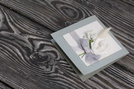 Homemade greeting card. Against a background of brushed pine boards.