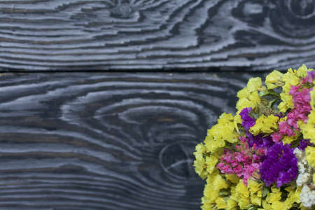 A woman places a dessert of cream and biscuit crumbs on the table. Close-up shot.の写真素材