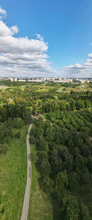 City landscape. Nearby there is a park area. Blue sky with white clouds. Aerial photography of the...