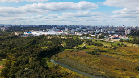 City landscape. Nearby there is a park area. Blue sky with white clouds. Aerial photography.の写真素材