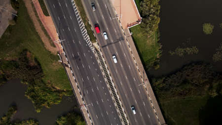 An overpass across the city river. Busy freeway. Aerial photography.