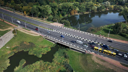 An overpass across the city river. Busy freeway. Aerial photography.