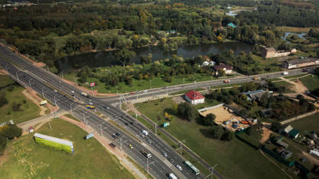 An overpass across the city river. Busy freeway. Aerial photography.