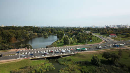 An overpass across the city river. Busy freeway. Aerial photography.の写真素材