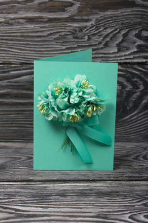 Homemade handmade postcard. On black pine boards.の写真素材