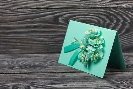 Homemade handmade postcard. On black pine boards.の写真素材