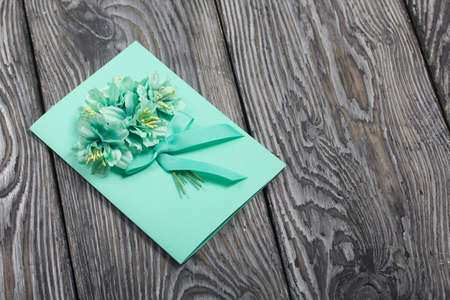 Homemade handmade postcard. On black pine boards.