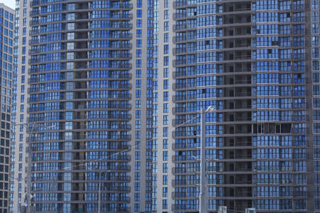 Construction of modern multi-storey buildings. Construction of a new city block. Buildings under construction are visible.の写真素材