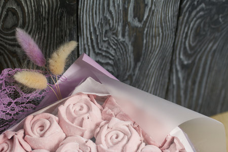 Marshmallow bouquet packed in craft paper. Zephyr rose flowers.の写真素材