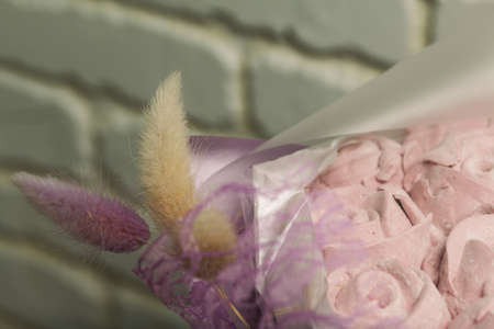 Marshmallow bouquet packed in craft paper. Zephyr rose flowers.の写真素材