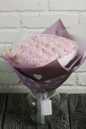Marshmallow bouquet packed in craft paper. Zephyr rose flowers.の写真素材